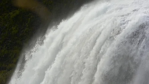 Water gushing from the crest of the waterfall Stock Footage 74906631