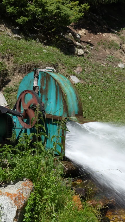 Water gushing from old turquoise generator wheel Stock Footage 342025389