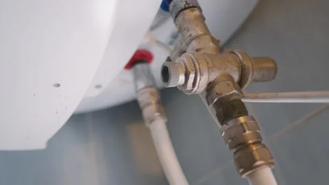 Water Heater Pipe Fitting Close Up: Brass Valve Connection with Flexible Hoses Stock Footage 342198158