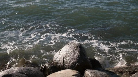 Water hitting rocks slow motion with waves shot in high resolution Stock Footage 87838399