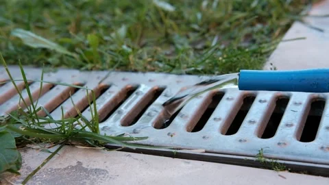 The water from the hose is poured into the drain. Stock Footage 156815034