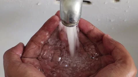 Water in human hands. stream of pure water pouring into male hands. Stock Footage 154162165