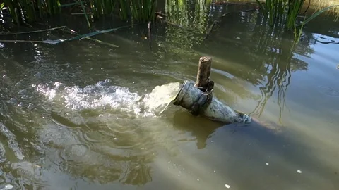 Water inflow through the pipe into the pond Stock Footage 120556140