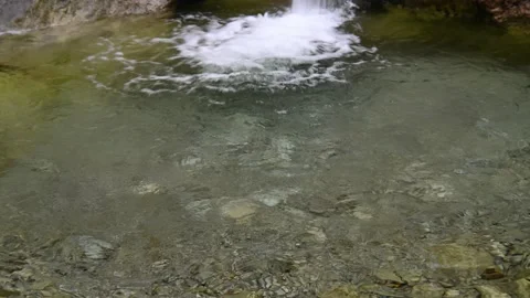 Water inside of a natural pool formed by a mountain stream Video stock 211467948