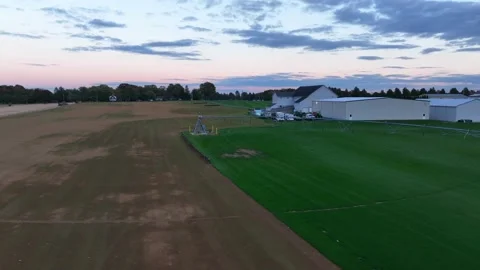 Water irrigation system at turf grass sod farm. Aerial view of coils and Stock Footage 231744250