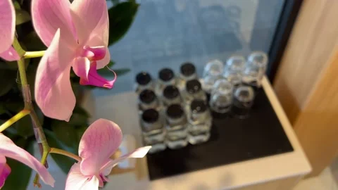 Water jars with lids and upside down glasses on a lounge table near a window Stock Footage 323921947