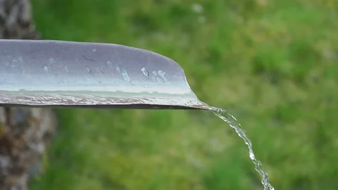 Water jet in metal gutter in the rain Stock Footage 153284875