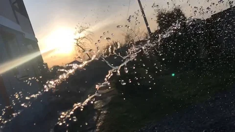 The Water jet watered on evening background Video stock 129866864