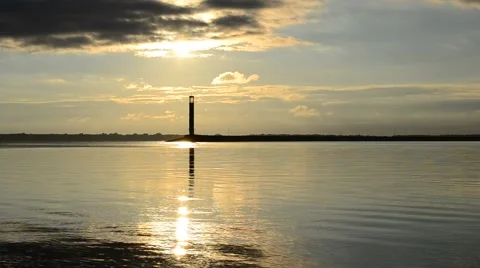 Water landscape with lighthouse and clouds during daybreak Stock Footage 55018269