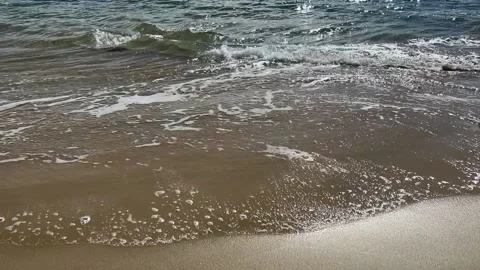Water lapping at beaches waters edge. Stock Footage 238901849