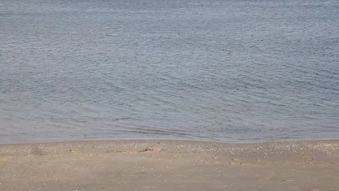 Water lapping shore on sandy beach Stock Footage 110744090