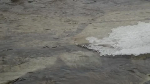 Water laps a sandy shoreline 스톡 동영상 166004718