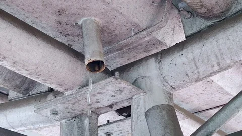Water leakage from ceiling pipe in building structure Stock Footage 328131556