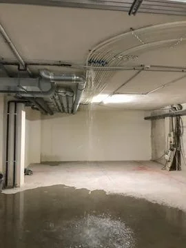 Water leaking from building ceiling causing flood damage Stock Photos