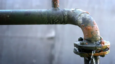 Water leaking from old rusty water supply pipe control valve assembly Stock Footage
