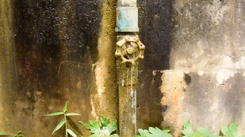 Water leaking from old valve on the wall. Stock Footage 80598424