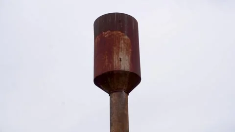 Water is leaking out of a rusty water tower. The metal is rusted. Stock Footage 334947939