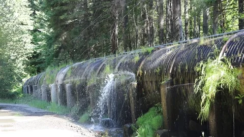 Water leaking from a pipe on Rogue Umpqua highway Oregon USA Stock Footage 340243223