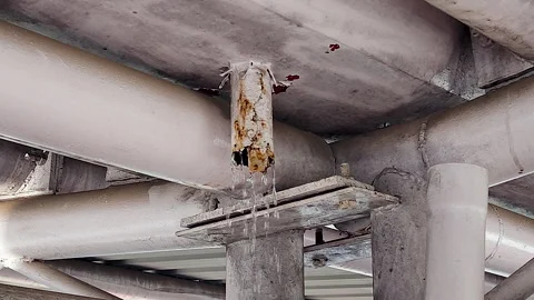 Water Leaking From Rusty Industrial Pipe Under Metal Structure Stock Footage 342328018