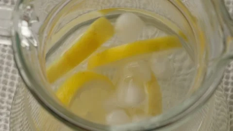 Water with lemon and ice cubes Stock Footage 313622076