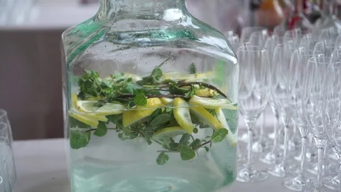 Water with lemon and mint and empty flutes on the wedding catering in .. 스톡 동영상 75453549
