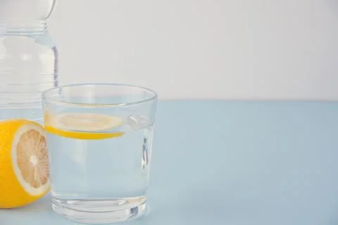 Water with lemon on the blue table Stock Photos