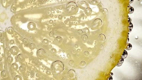 Water with Lemon Slices and exploding soda, air bubbles. Refreshing soft drink Stock Footage 178989221