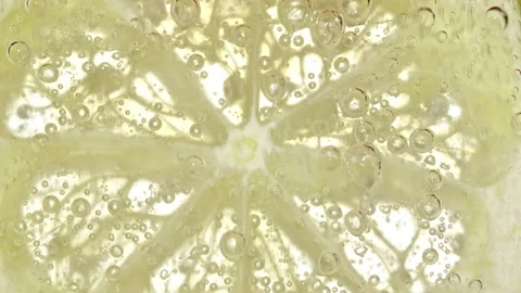 Water with Lemon Slices and exploding soda, air bubbles. Refreshing soft drink Stock Footage 194474356