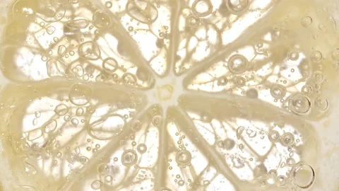 Water with Lemon Slices and exploding soda, air bubbles. Refreshing soft drink Stock Footage 195978773