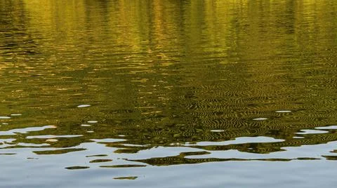 The water level in the river, which reflects the green slopes on the opposite Stock Photos