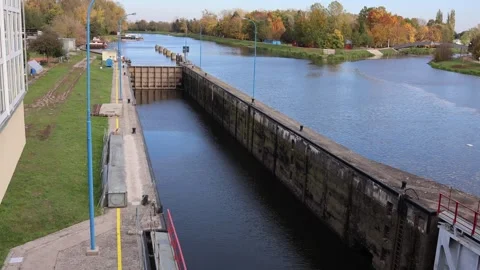 Water lock and canal surrounded by colorful autumn trees under clear blue sky ca Stock Footage 319842104