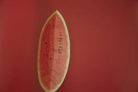 Water melon slice isolated on red background Stock Photos