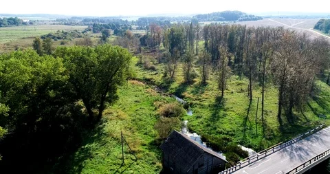 Water mill on the river. The sun is reflected in the water. 4K Stock Footage 96481484