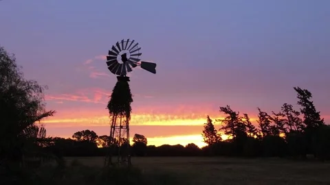 Water mill turning gently in the evening illuminated by sunset light in bac.. Stock Footage 252397738