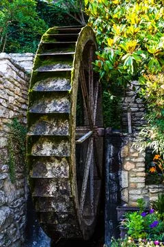 Water mill. The wheel of the water mill. The mill is a river. Stock Photos