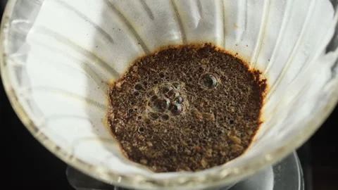Water mixed with coffee going through fabric coffee filter Video stock 306214053