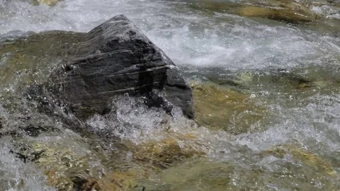 Water in a mountain river in slow motion video. Stock Footage