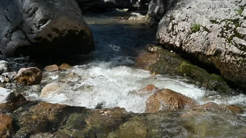 Water from a mountain stream in direct sunlight Video stock 219357208