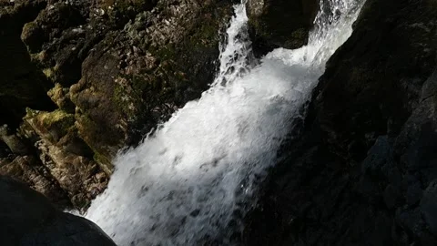 Water from a mountain stream falling in summer sunlight (slow motion) Stock-Footage 219395760