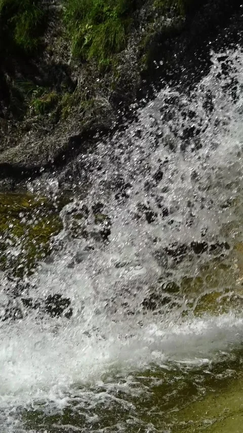 Water from a mountain stream falling in the summer, vertical, slow motion Stock-Footage 260911807
