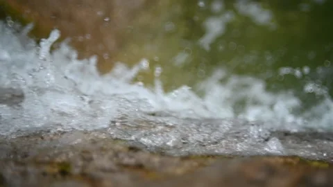 Water from a mountain stream falls over rocks (slow motion, cloudy) Stock-Footage 219635115