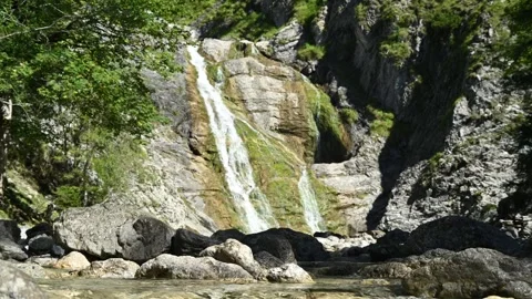 Water from a mountain stream in front of a beautiful waterfall 스톡 동영상 260845551