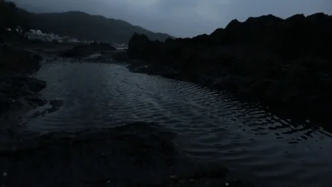 Water moved by the wind on a black beach Stock Footage 75213038