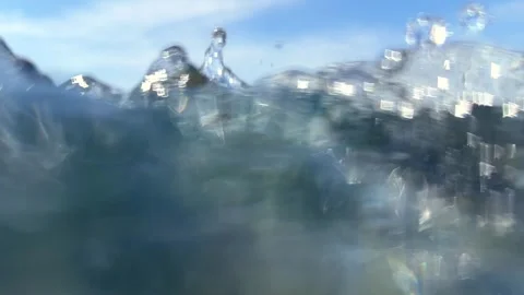 Water movement beneath the ocean surface creates drifting air bubbles through se Stock Footage 339279402