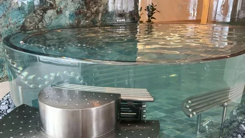 Water moving gently in empty round hotel pool Stock Footage 294954005