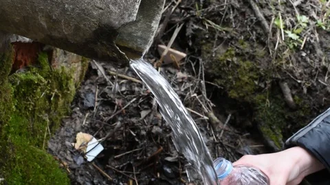 The water from the natural spring is crystal clear cool for drinking and cooking Stock Footage 89610837