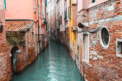 Water next to a brick building Stock Photos