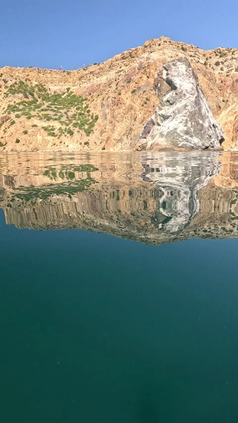 Water ocean mountain, tranquil split view of rocky coast, clear sea reflecting Stock Footage 321057270