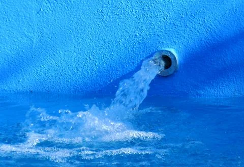 Water outlet through a pipe Stock Photos