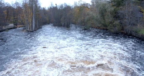 Water output from hydroplant streaming down a forest in northern Sweden. 스톡 동영상 163217430
